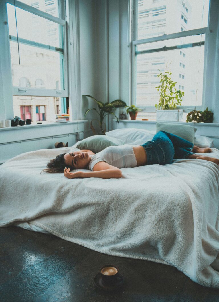 A woman lying on her bed.